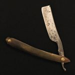his straight razor from the House of the Temple Library & Museum's collection features Masonic symbols on its blade.