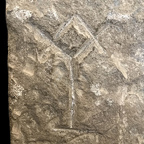 Detail of the White House Stone, featuring a stone mason's mark resembling a square & compasses